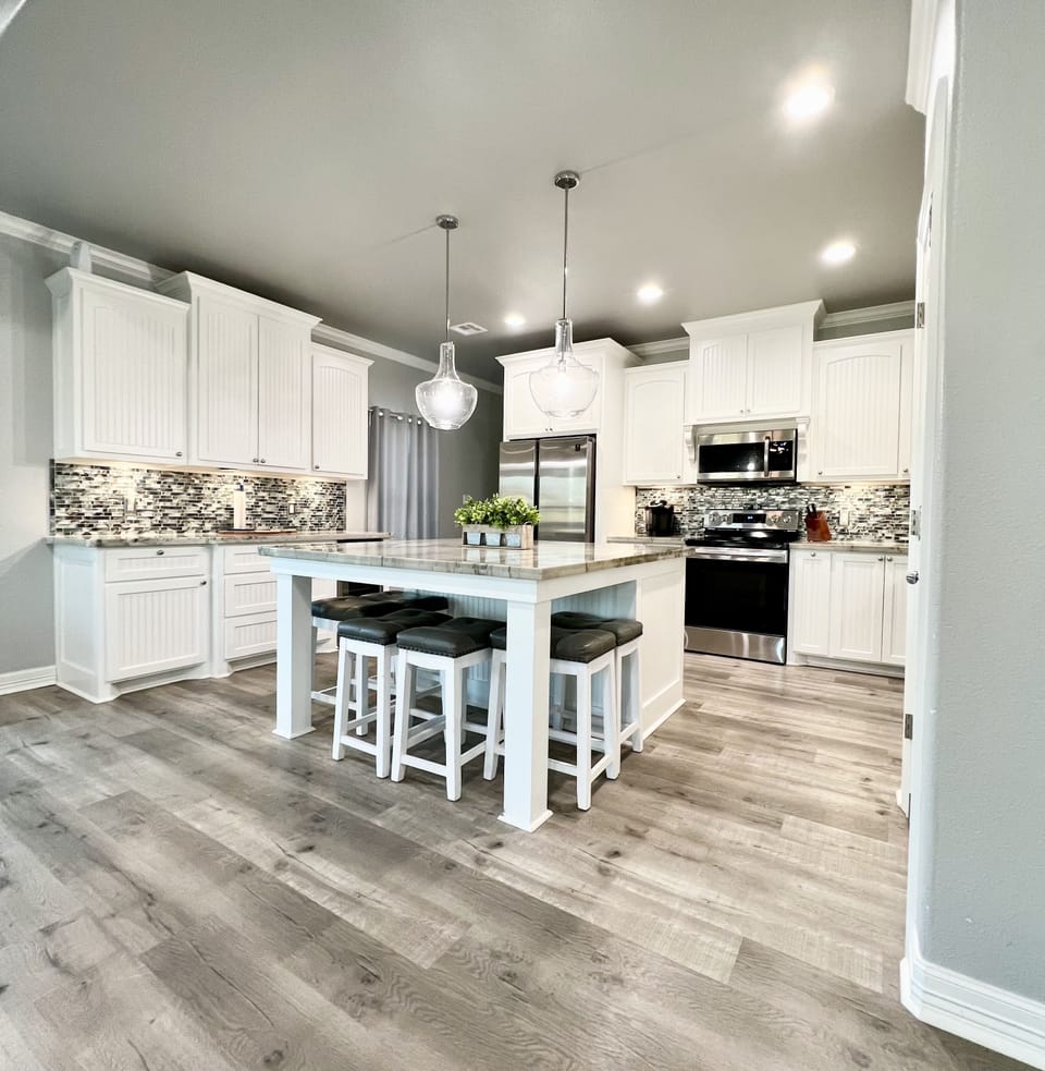 Kitchen space with 8 stools and a large island.