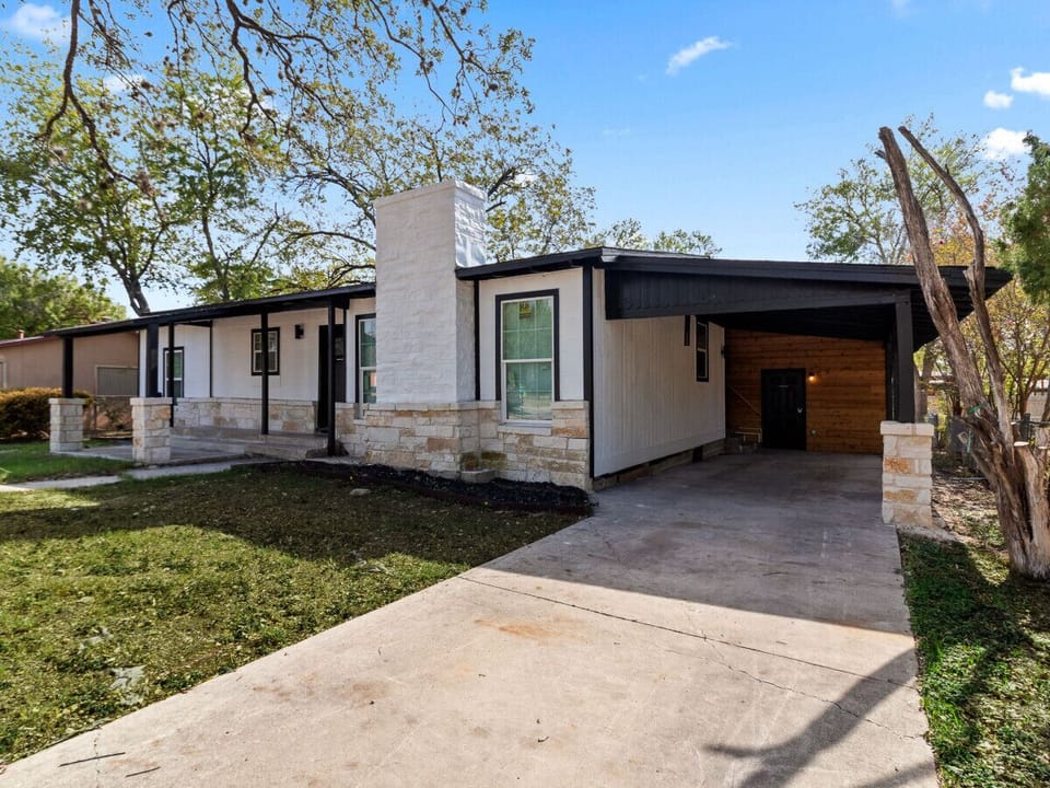 Front View of Home: Carport Parking for Unit B and Unit B Side Entrance