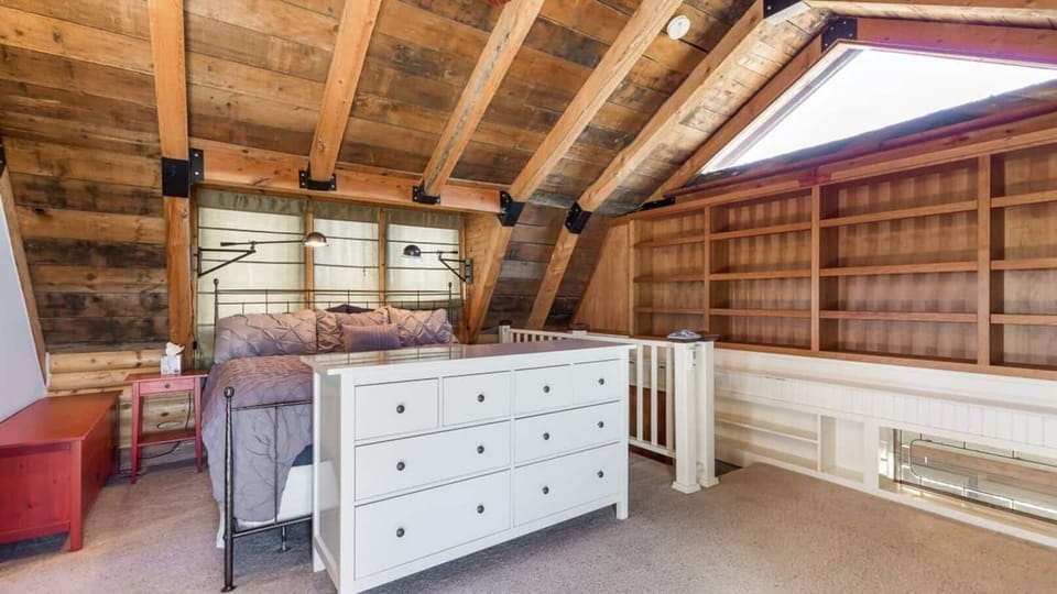 The master bedroom, located upstairs, has a king bed, en suite bathroom, a sauna, a dedicated workspace, and a private deck.