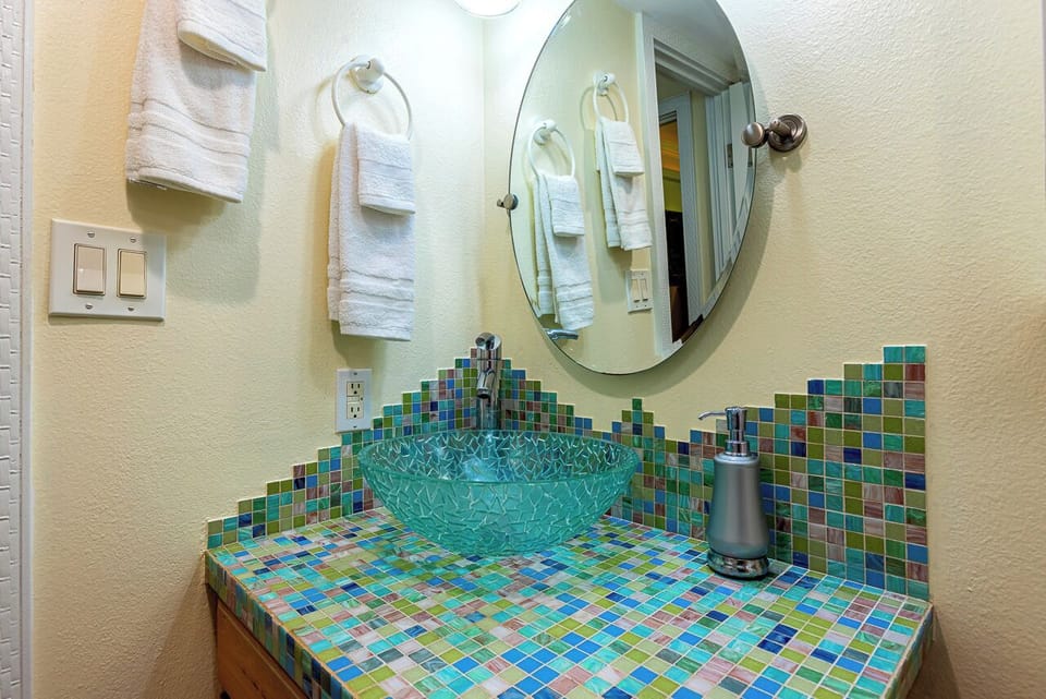 Gorgeous guest bathroom with hand painted glass tile