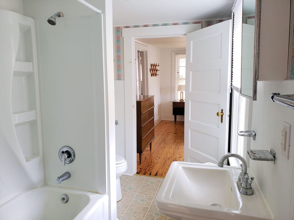 1st Level. Full Bath w/Shower/Tub Combo. 2 Doors. One leading to Master Bedroom. Other leading to Living Room