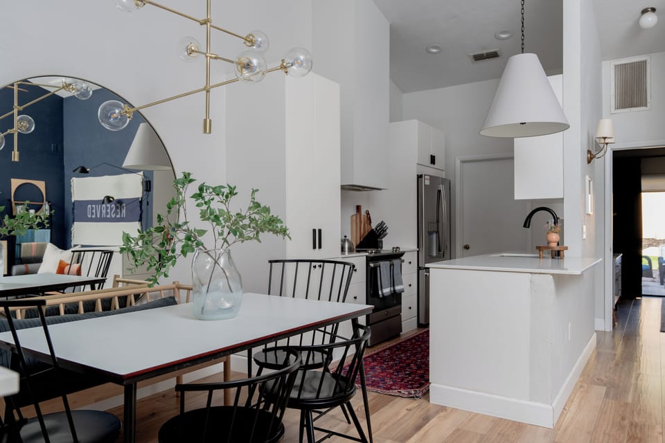 Kitchen is open to dining (seats 7) and living room with vaulted ceilings and skylight