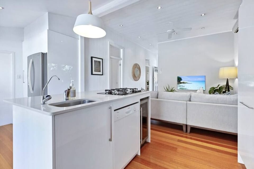 Open plan kitchen with Miele oven and microwave, refrigerator.