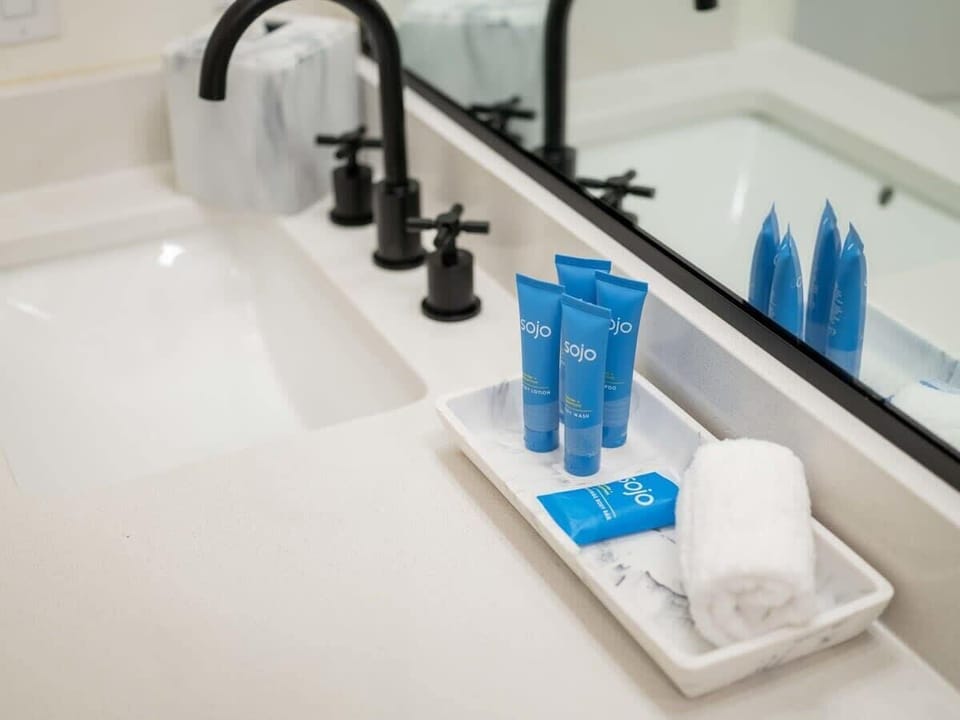Pamper yourself with spa-like toiletries neatly arranged on a marble countertop.