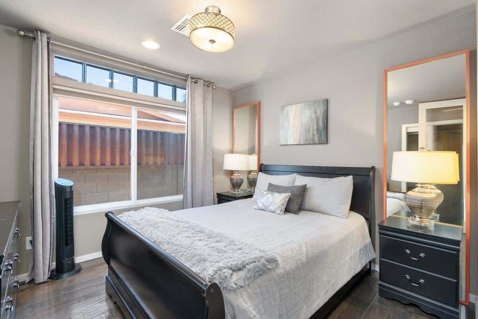 Bedroom 3 welcomes you with luxe furnishings, a queen-size bed with a memory foam mattress, accent lighting, and ample storage in the stylish designer dresser.