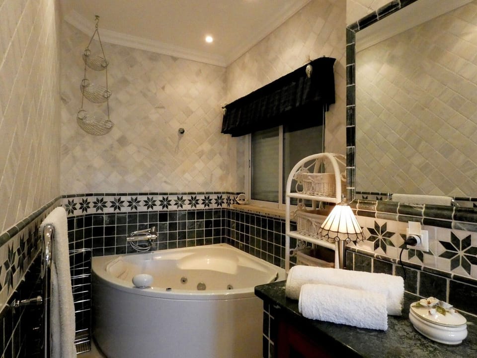 Master bathroom with large corner spa bath and shower.