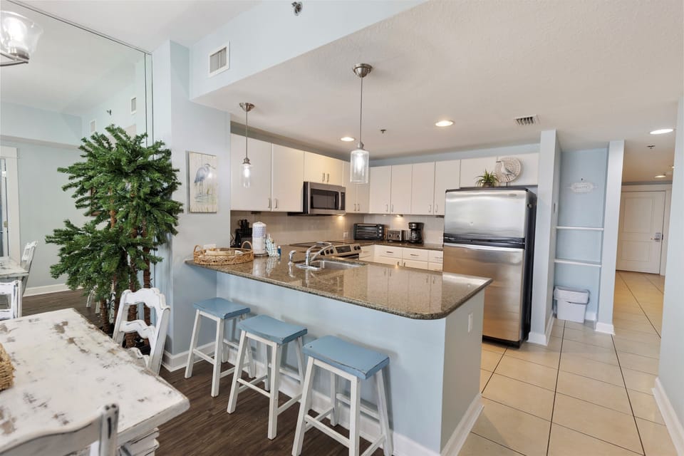 Your modern kitchen awaits with granite countertops, stainless steel appliances, and a breakfast bar perfect for morning coffee or casual dining.