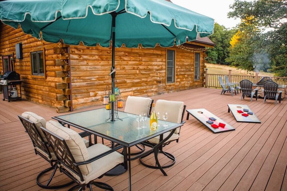 Massive balcony with outdoor dining, corn hole game, fire pit and a gas bbq. 