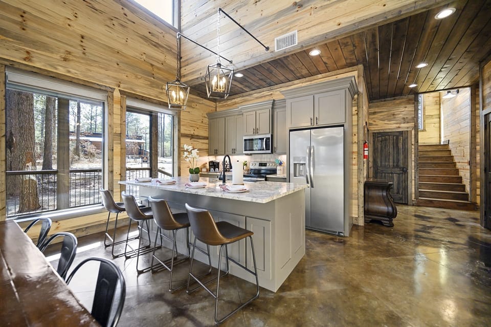 Kitchen with stairs in background leading to master bedroom