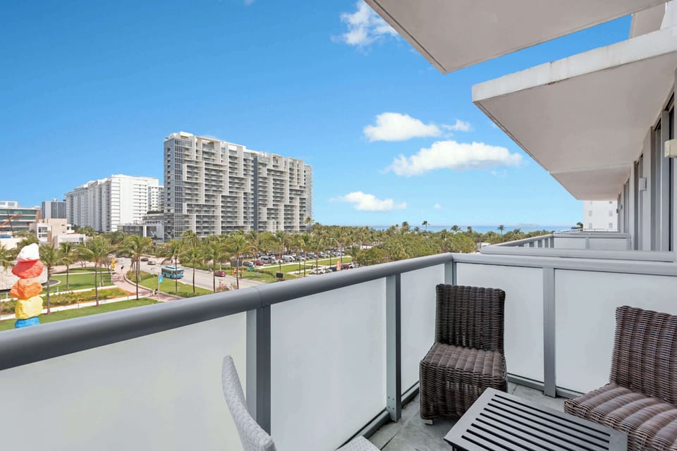 Enjoy this private balcony with chairs, a table and sun loungers.