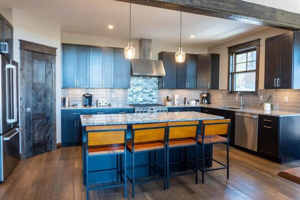 The fully-equipped kitchen is a beautiful space to put together a delicious meal all while staying connected with your loved ones in the open space.