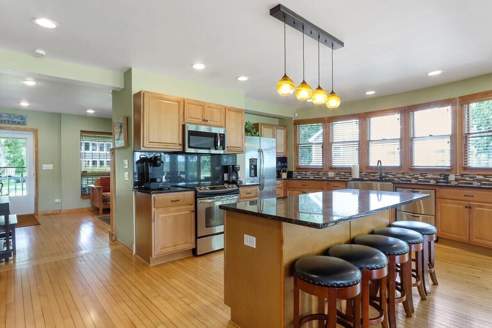 Open concept kitchen with breakfast bar seating for 5