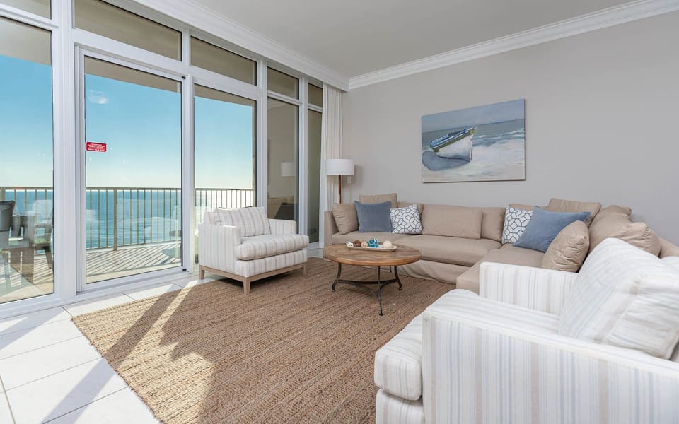 Relax in the inviting living room, where natural light floods in and views of the coast await