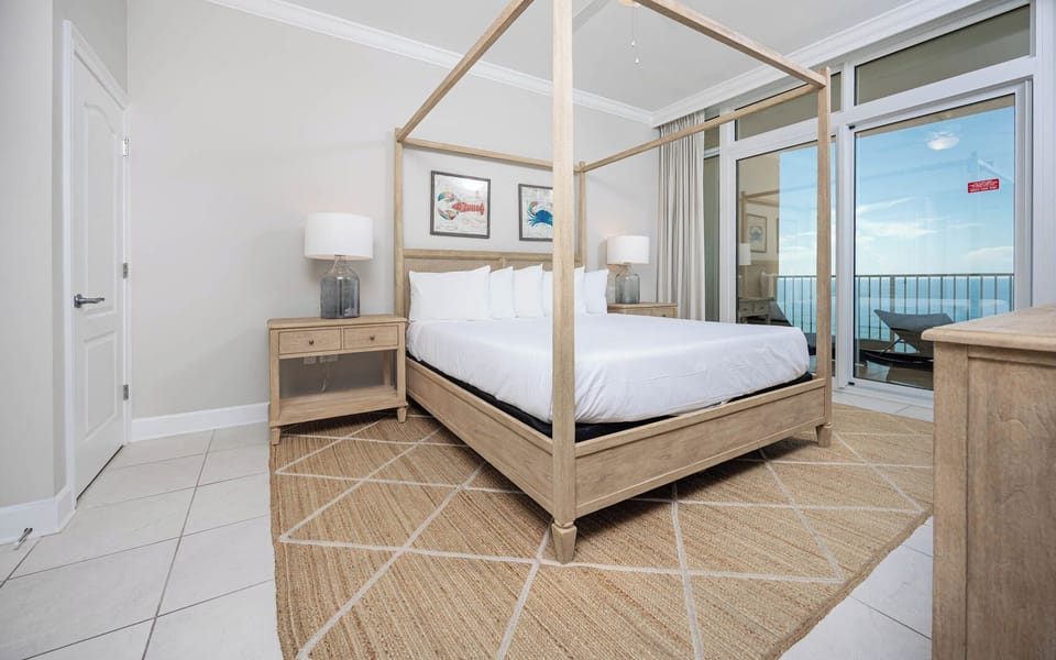 Retreat to the king master suite with cozy bedding and drift off to the sound of the waves from the balcony