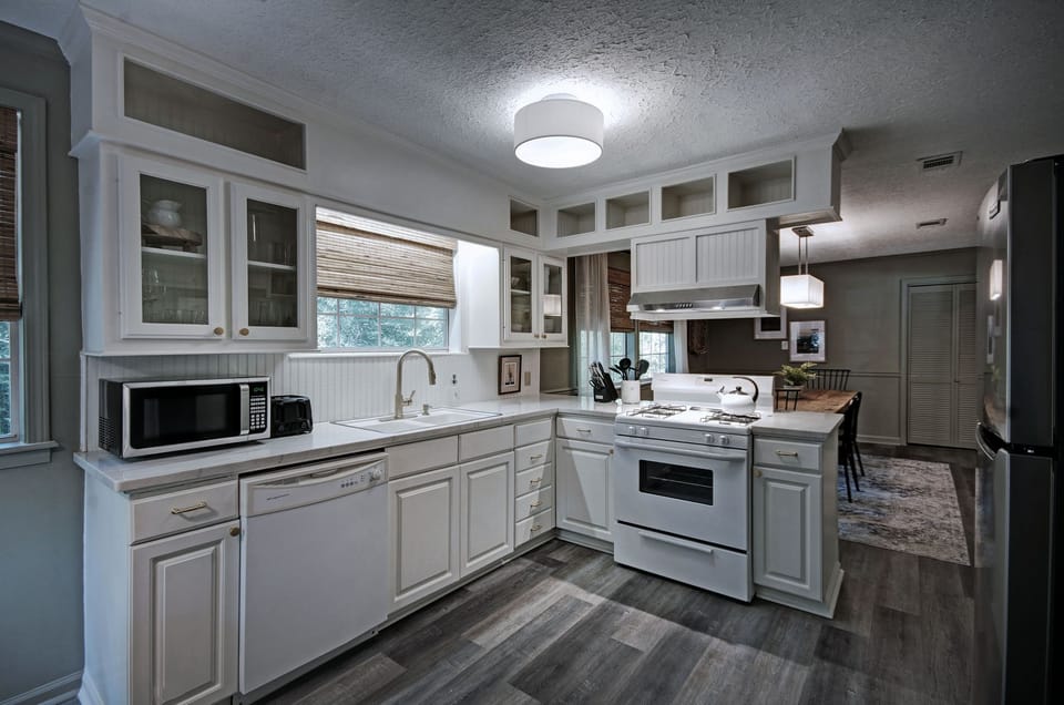 The renovated kitchen with a stove, oven, dishwasher, microwave, refrigerator, kettle, and a Keurig with pods.  Perfect for a corporate stay.