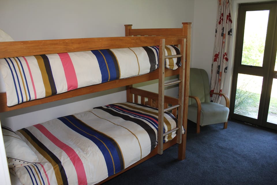 The downstairs bedroom has bunk beds, or two singles, or the bunks plus a single