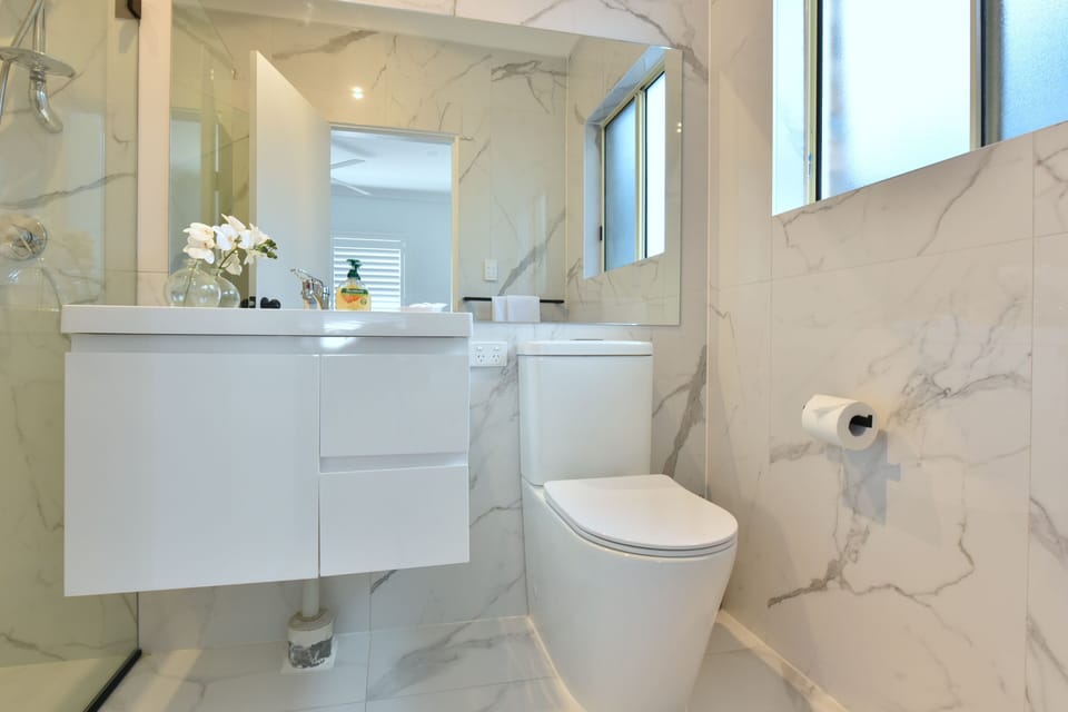 This bathroom gives a nod to the home's midcentury origins.