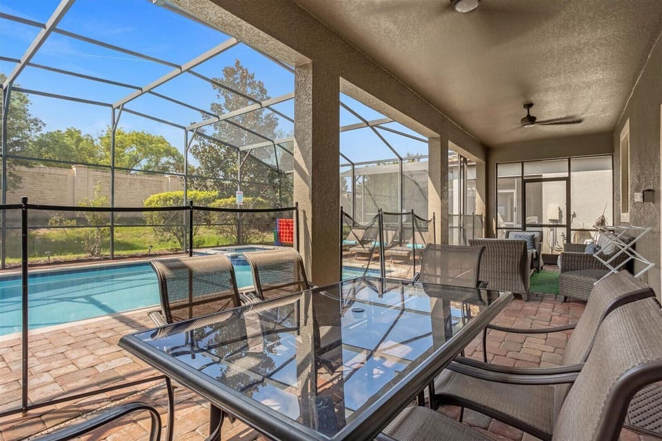 Covered Lanai with pool safety fence, pool door alarms, and plenty of seating