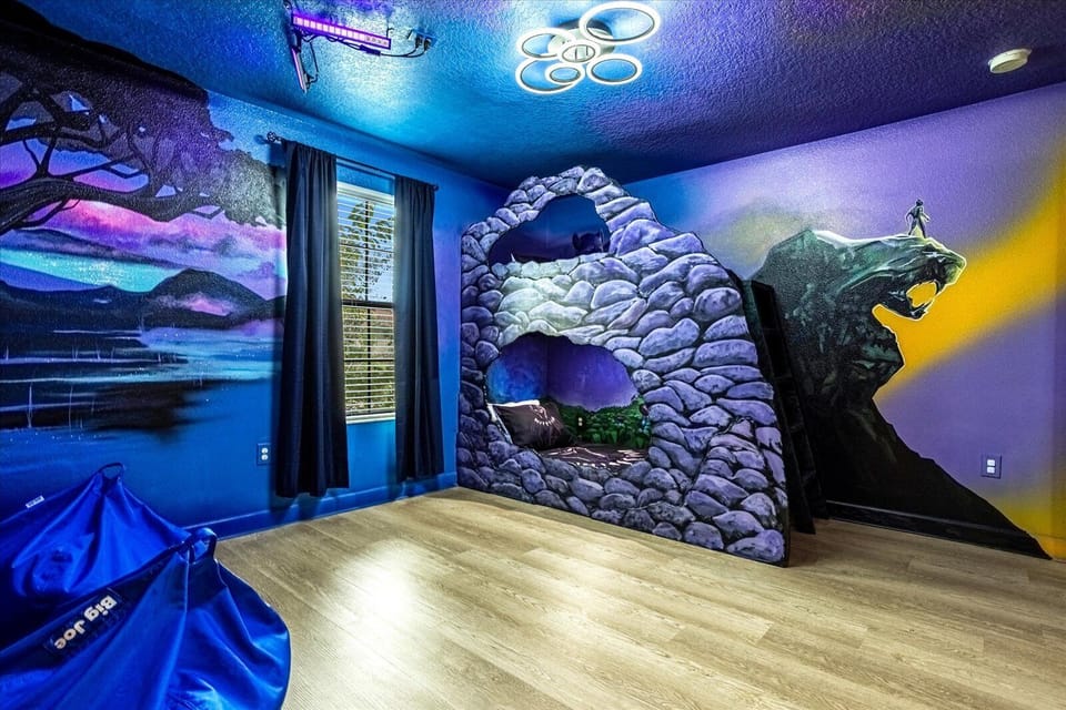 Black Panther Room with custom bunk bed, 43" TV, and murals of Avengers.