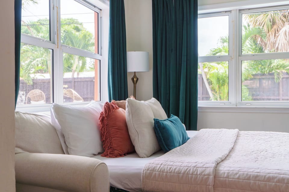 Relax in the sunroom w/ a queen sleeper sofa, blackout curtains & 50" smart TV.