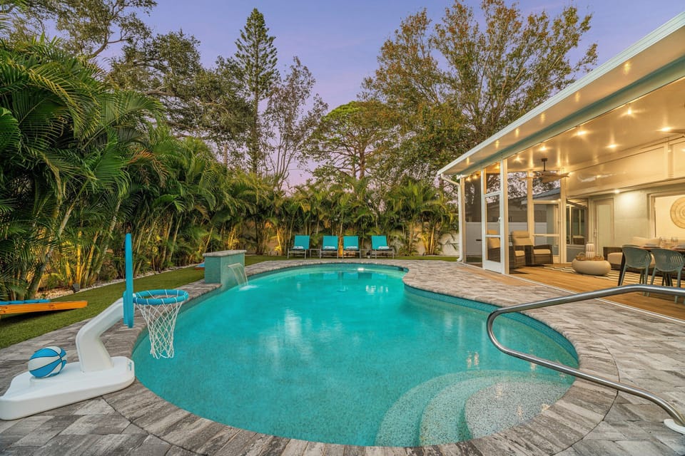 The local beaches are incredible but it's hard to beat a sand free pool day in your own backyard with comfy lounge chairs on the turf yard, a relaxing waterfall, and fun games like water basketball!