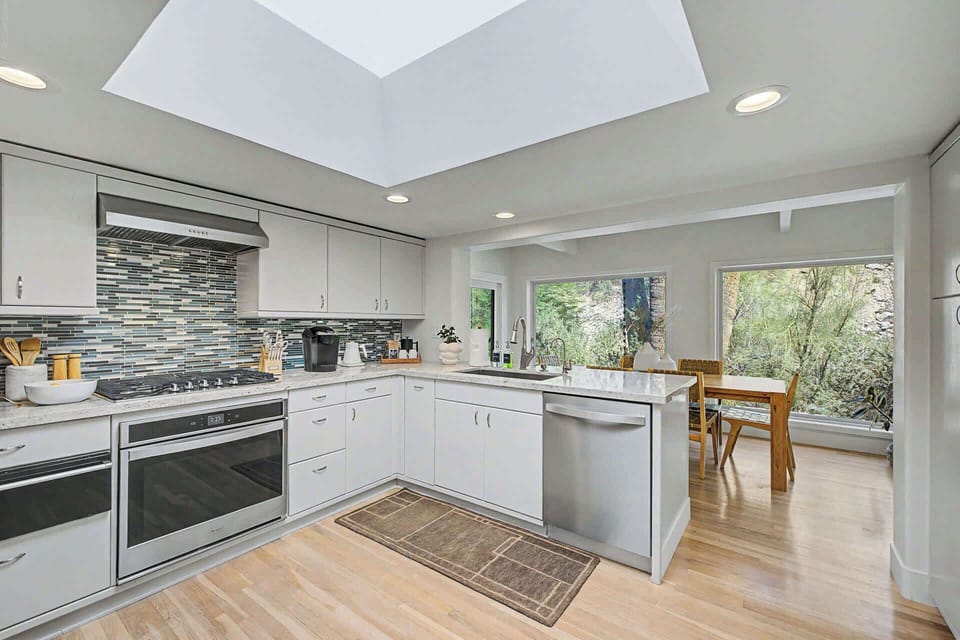 Well-appointed chefs kitchen with stainless steel appliances and gas cooktop
