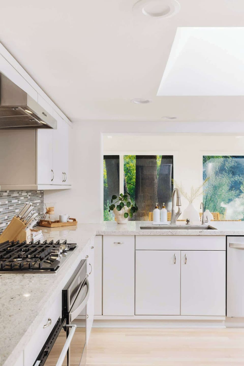 Well-appointed chefs kitchen with stainless steel appliances and gas cooktop. 