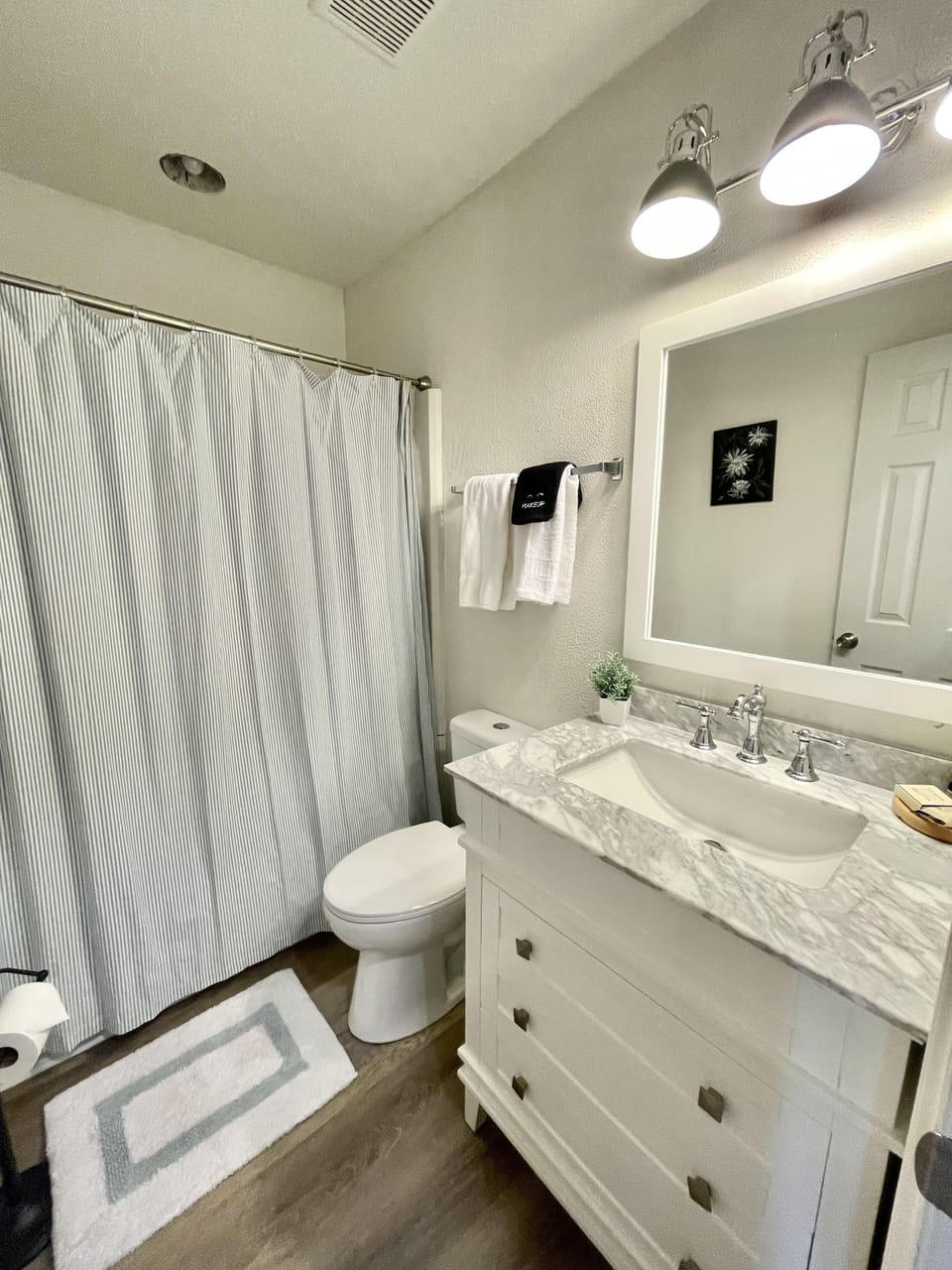 Hall bath with tub/shower combo.