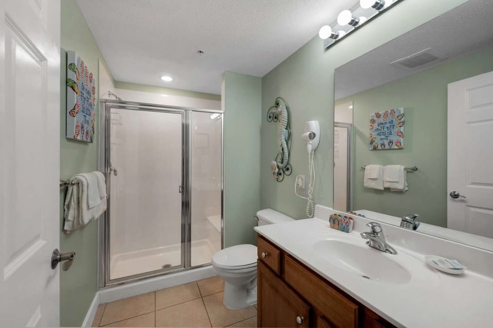 Modern bathroom with a glass-enclosed shower and wooden vanity.