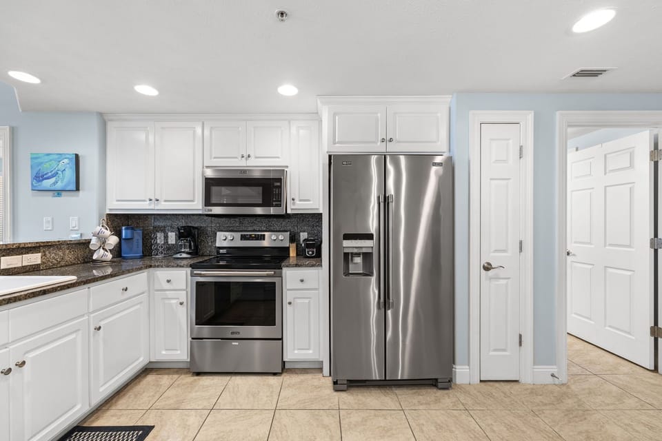 Modern kitchen with stainless steel appliances and white cabinetry