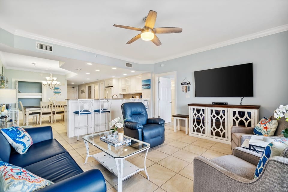 Open living area with modern seating and a large flat-screen television