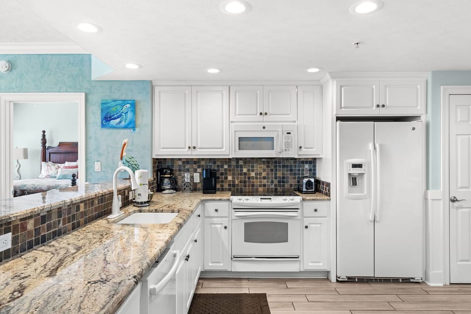 Your fully equipped kitchen invites relaxed meal prep with granite counters, coastal accents, and every appliance you need for a comfortable stay.