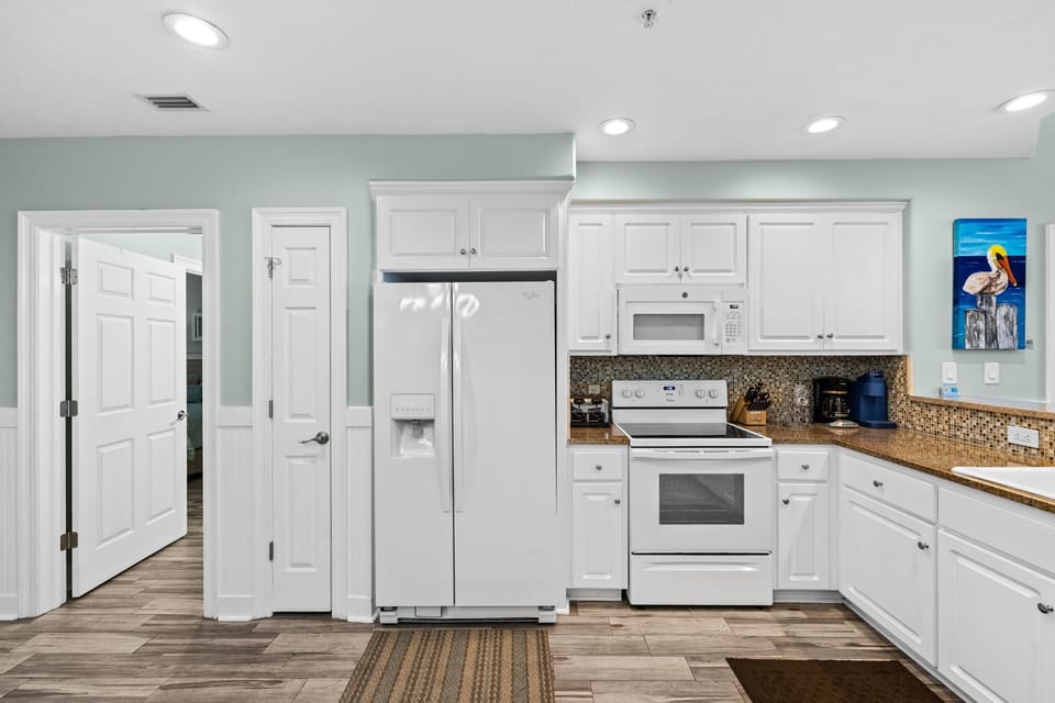 modern kitchen with white cabinetry and granite countertops