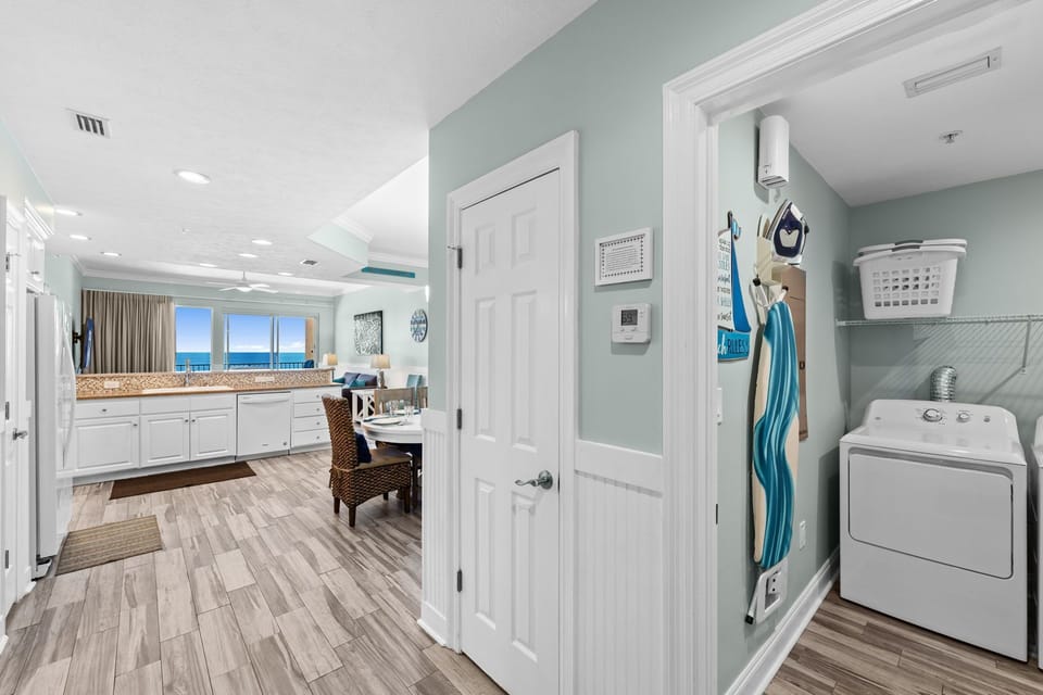 Open kitchen and dining area with ocean views and a laundry nook.