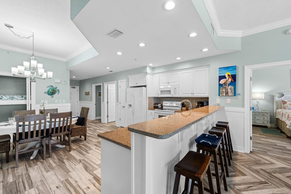 Open kitchen and dining area with modern finishes and ample seating.