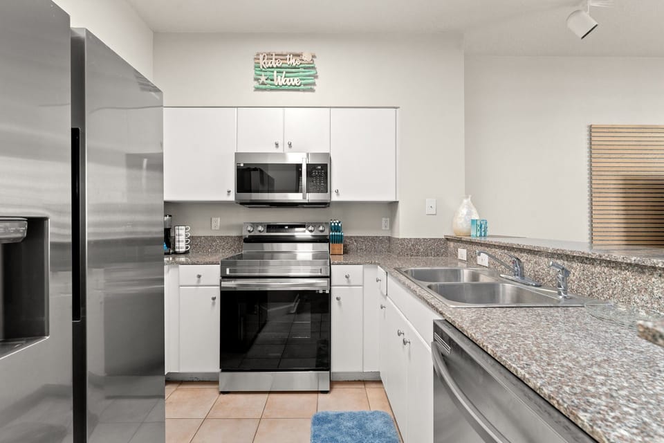 Modern kitchen with stainless steel appliances and granite countertops