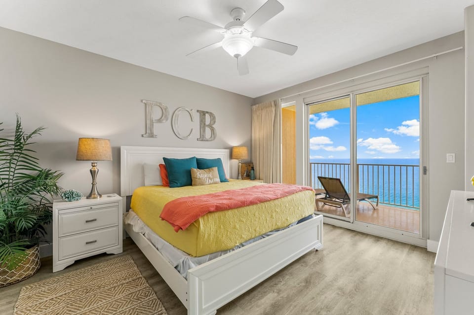 Relax in this bright bedroom with ocean views and direct balcony access.