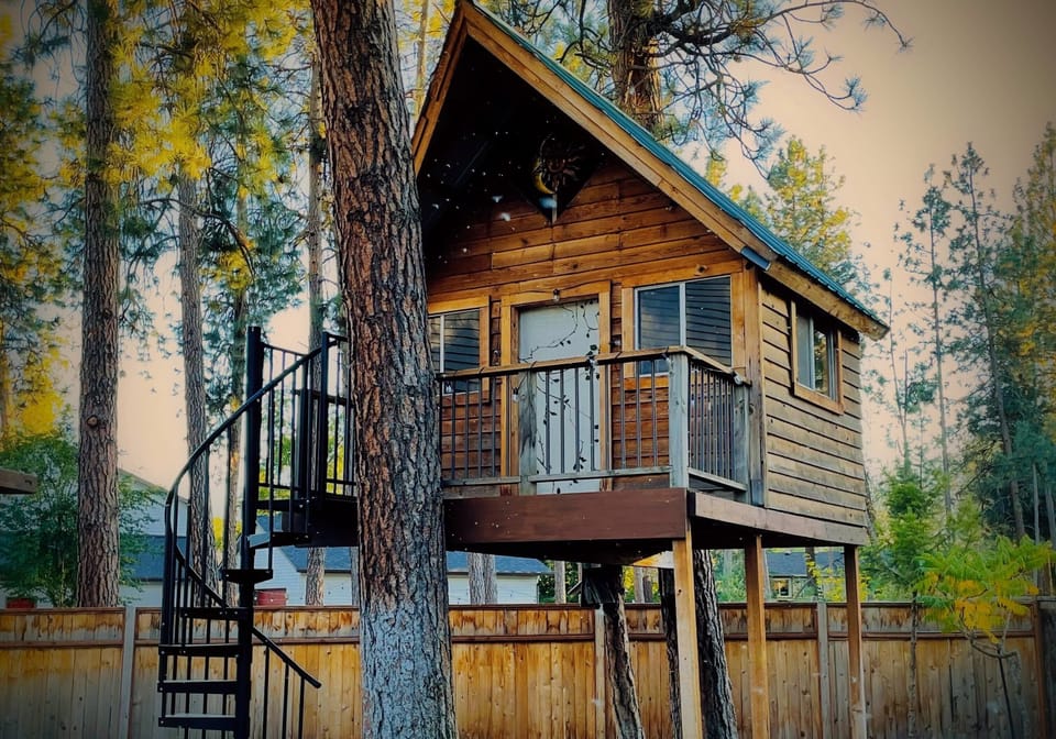 Cozy backyard treehouse is captivating for the young at heart.