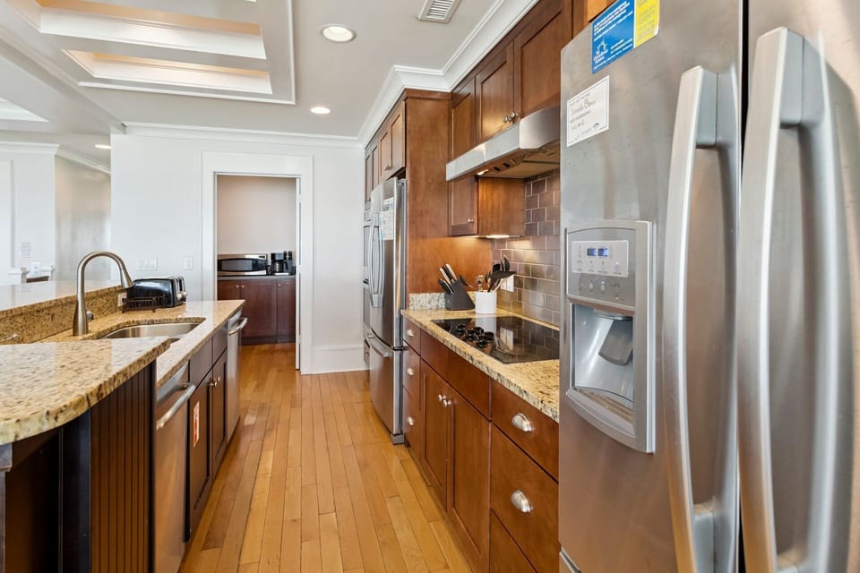 The open-concept kitchen is fully equipped with modern appliances and two dishwashers.