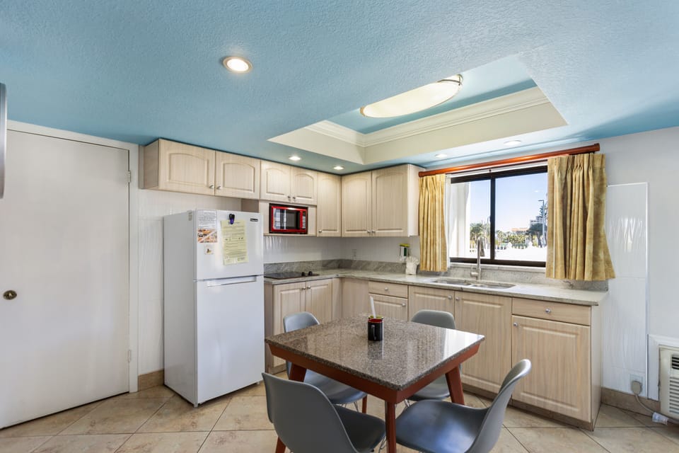 Deluxe Suite, 1 Bedroom (2 Queen beds and 1 Sofa bed) | Private kitchenette | Full-size fridge, microwave, stovetop, coffee/tea maker