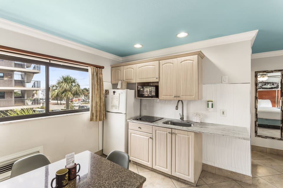 Deluxe Suite, 1 King Bed with Sofa bed (Efficiency) | Private kitchenette | Full-size fridge, microwave, stovetop, coffee/tea maker