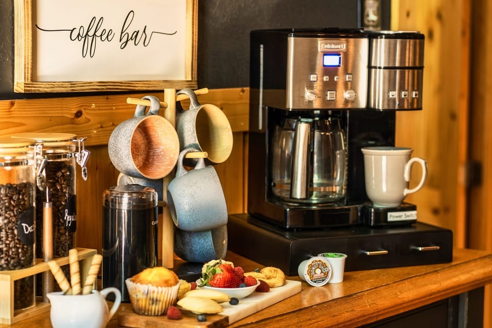 Indulge in a rich, aromatic cup of coffee or tea at the fully stocked coffee bar, featuring an extensive selection of premium coffee beans and tea blends. Sit out in the adjoining deck and blend in to nature