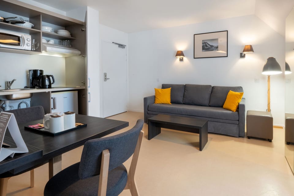 An inviting view into the kitchenette showcases modern appliances and ample storage, ensuring that families can easily prepare meals and snacks, enhancing their stay's comfort.