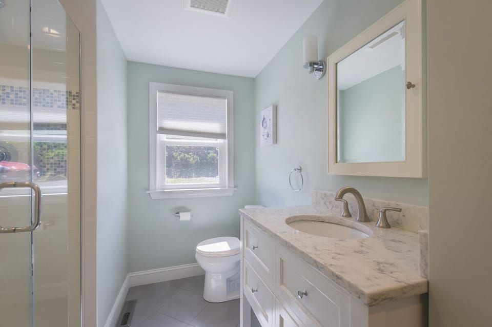 Full bathroom with standup shower and granite counters.