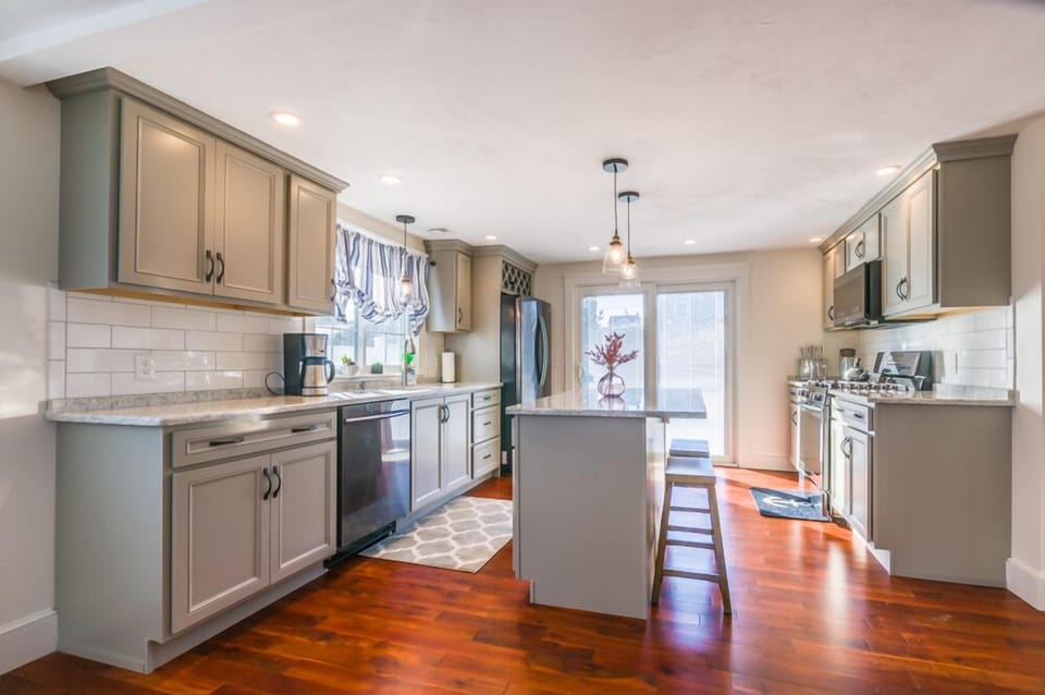 Large updated Kitchen with appliances and island that seats two guests.