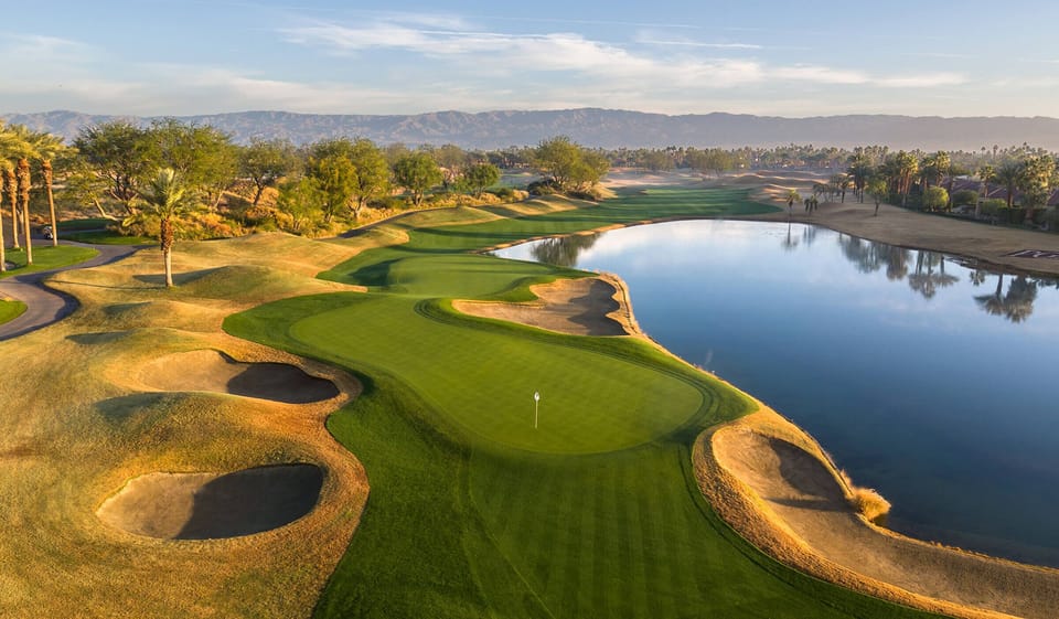 Scenic golf course views with tranquil water backdrop