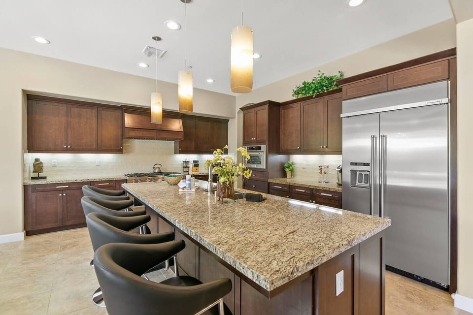 Gourmet kitchen with spacious bar and premium finishes