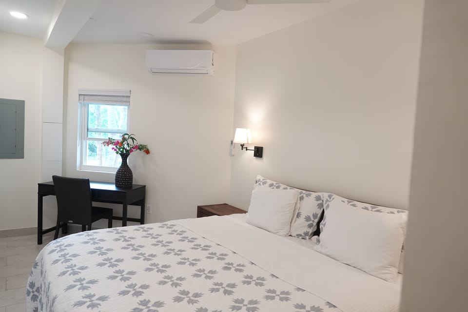 Sophisticated King Size Bed with an Exclusive Work Area and Picturesque Garden Vista