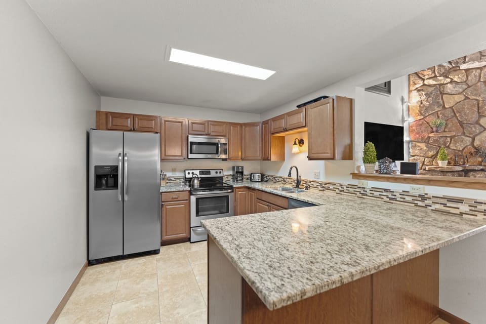 Full kitchen featuring all stainless steel appliances.