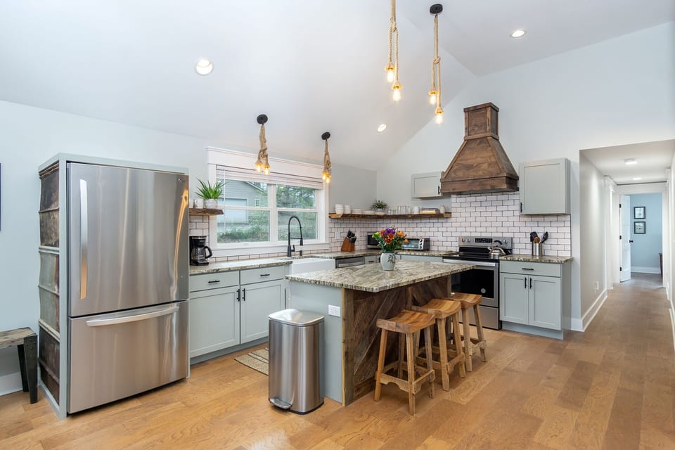 Kitchen complete with island with seating for 3, a dishwasher & a standard Drip coffeemaker.